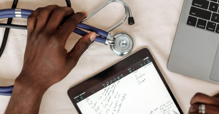 Doctor taking notes on tablet