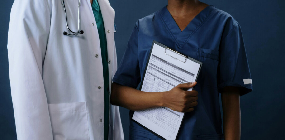A doctor and a nurse standing next to each other