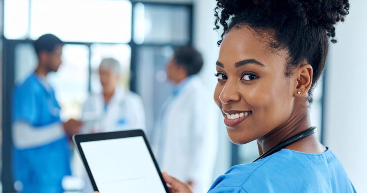 Firefly look over the shoulder of a afroamerican nurse who held a tablet in her hands 920836 2