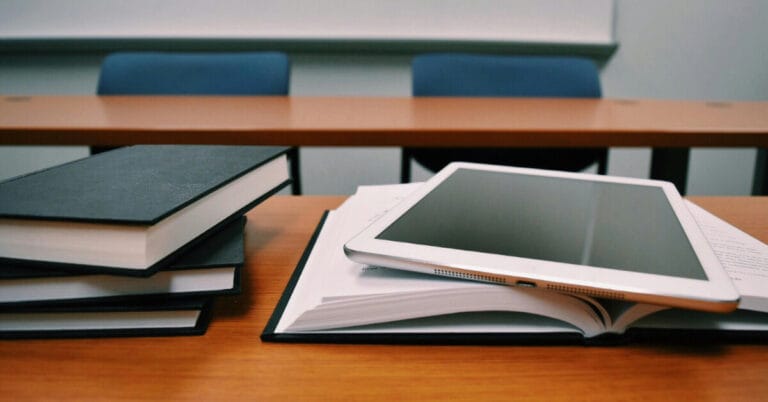 Books and a tablet on a desk