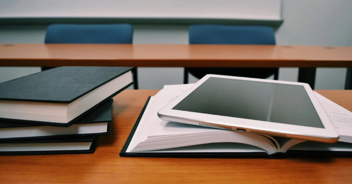 Books and a tablet on a desk