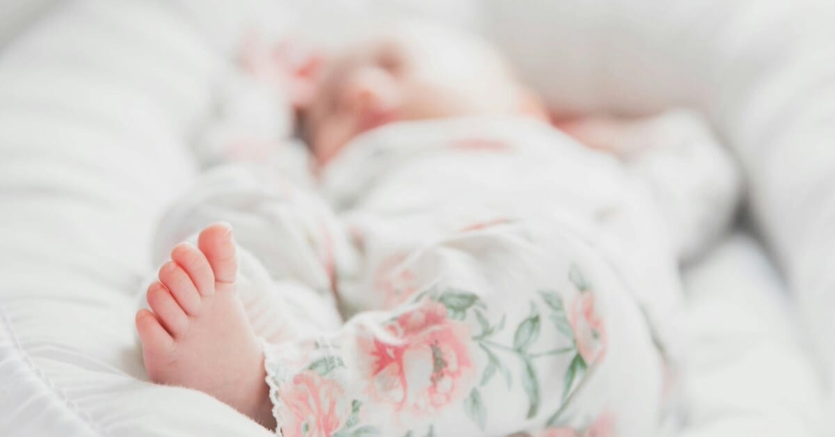 Baby lying in baby bed