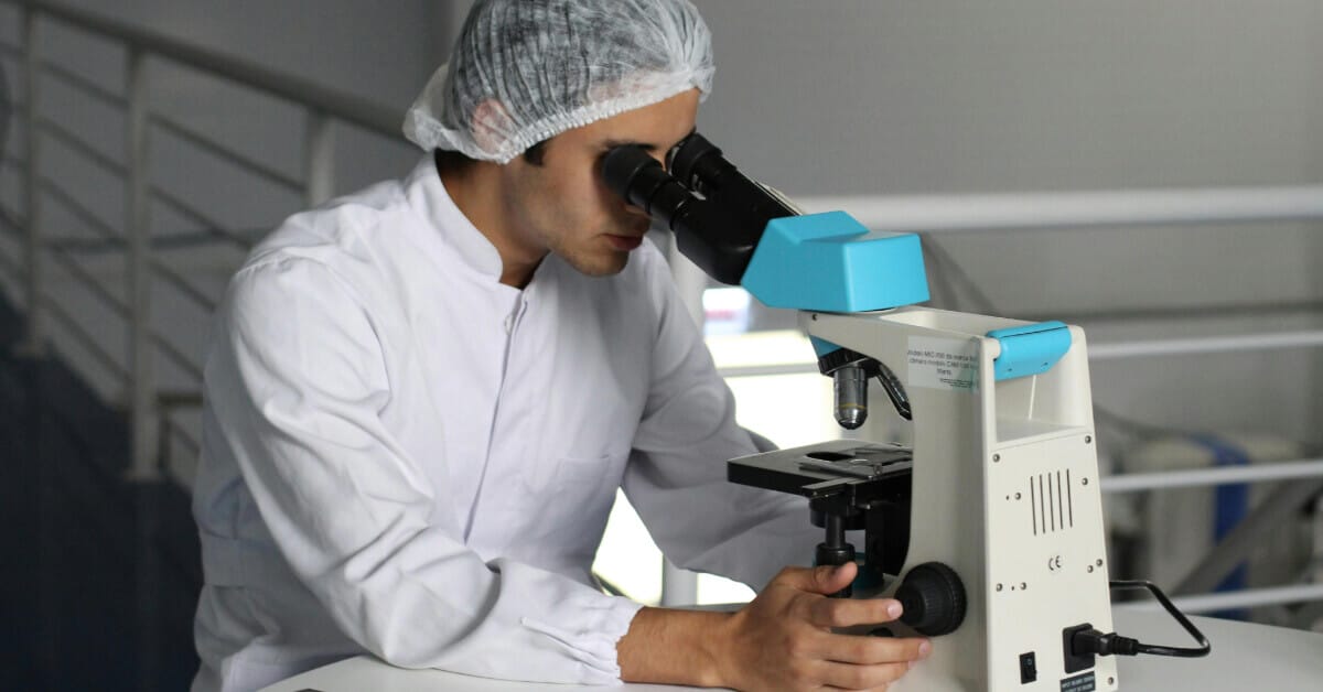 Doctor looking into a microscope