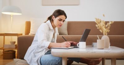 Young woman studying and taking notes