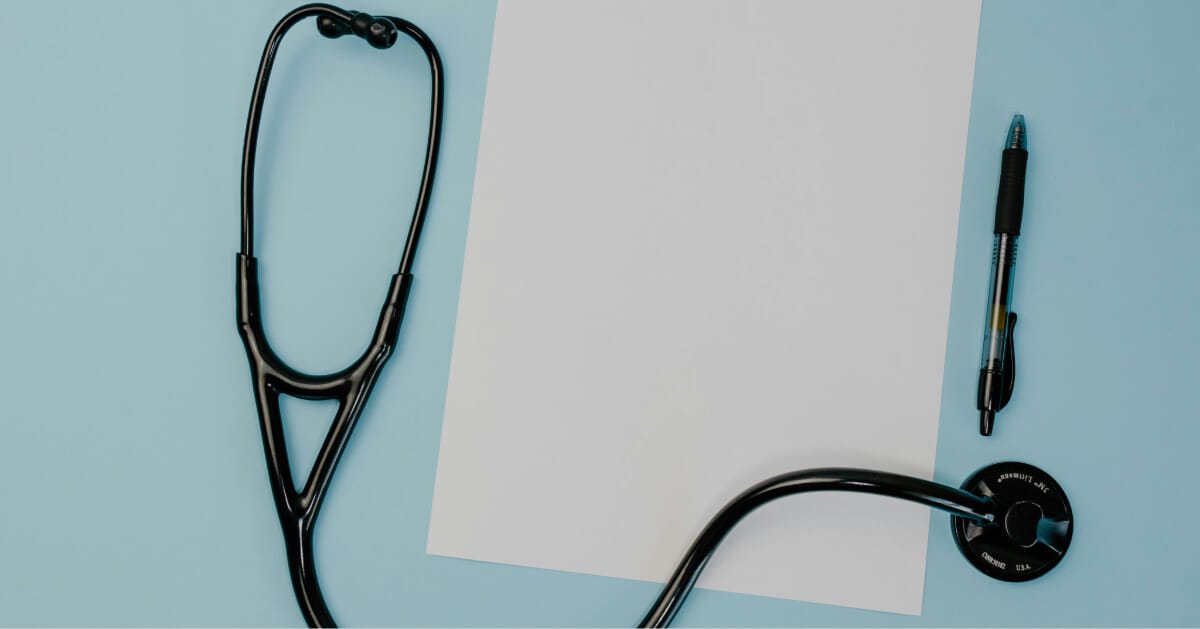 Desk with a notebook and a stethoscope