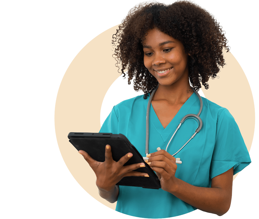 Smiling nurse in teal scrubs holds a tablet, wearing a stethoscope.