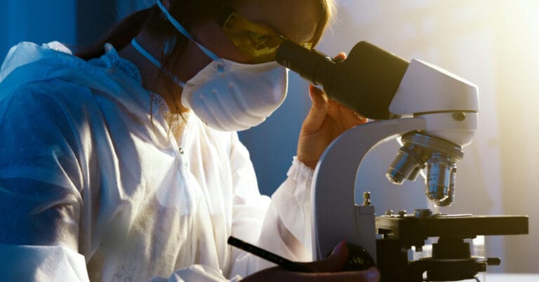 Doctor looking through a microscope