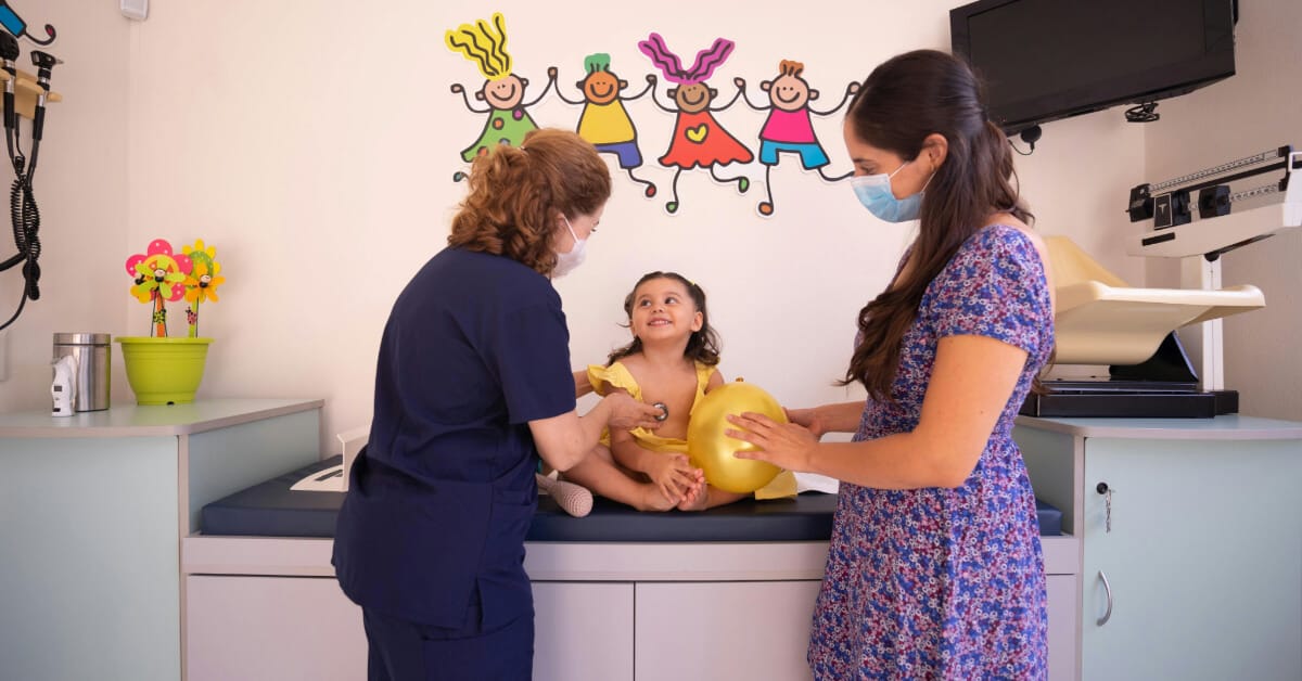 Pediatric nurse caring for girl