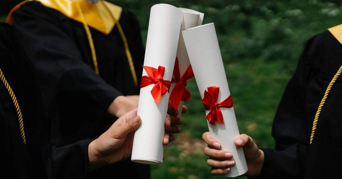 Graduates holding their diplomas